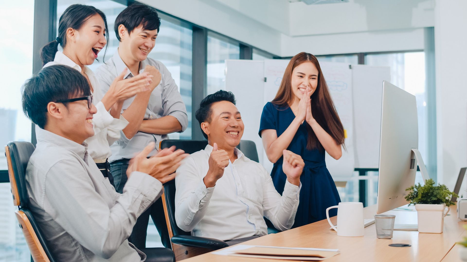 millennial-group-of-young-businesspeople-asia-businessman-and-businesswoman-celebrate-giving-five-after-dealing-feeling-happy-and-signing-contract-or-agreement-at-meeting-room-in-small-modern-office